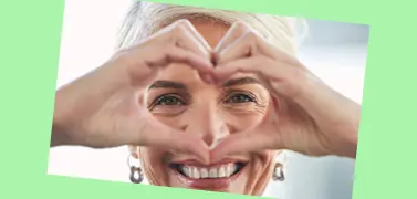 Eine Frau, die mit ihren Händen ein Herz formt